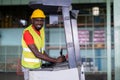 African American workers drive forklifts and wearing safety helmets and vests in the automotive parts warehouse. Transportation, Royalty Free Stock Photo