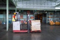 African American workers drive forklifts which holding many boxes with safety helmets and vests in the automotive parts warehouse Royalty Free Stock Photo