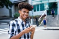 African american young adult using mobile phone for internet