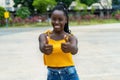 African american young adult woman with braids showing thumbs up Royalty Free Stock Photo