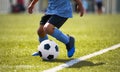 African American young boy playing soccer in a stadium pitch Royalty Free Stock Photo