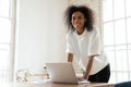 African american young business woman leaning over table. Royalty Free Stock Photo