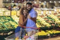 African american couple shopping for healthy fresh food at produce section of supermarket Royalty Free Stock Photo