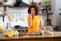 Healthy diet eating. African American young female preparing salad in kitchen. Pretty woman cooking healthy food. Royalty Free Stock Photo