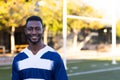 African American young male athlete standing on a football field, wearing a jersey, copy space Royalty Free Stock Photo