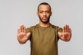 African american young man gesturing STOP with his hand over light grey background Royalty Free Stock Photo