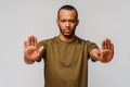 African american young man gesturing STOP with his hand over light grey background Royalty Free Stock Photo