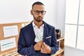 African american young man hiding dollars in jacket puffing cheeks with funny face