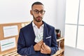 African american young man hiding dollars in jacket relaxed with serious expression on face