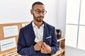 African american young man hiding dollars in jacket smiling looking to the side and staring away thinking