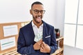 African american young man hiding dollars in jacket sticking tongue out happy with funny expression