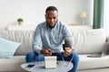 African American Young Man Measuring Arterial Blood Pressure At Home