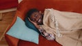 African american young man sleeping quietly in bedroom at home, smiling, lying on comfortable bed Royalty Free Stock Photo