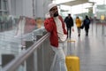 African American young man talking on smartphone travelling with luggage inside in airport terminal Royalty Free Stock Photo