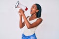 African american young woman protesting yelling through megaphone Royalty Free Stock Photo