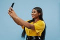 African-american young woman`s half-length portrait on blue background Royalty Free Stock Photo