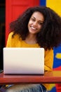 African american young woman sitting at cafe with laptop Royalty Free Stock Photo