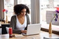 African american young woman sitting at cafe with laptop Royalty Free Stock Photo