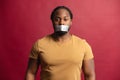 African angry man with his mouth sealed with tape Royalty Free Stock Photo