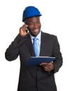 African architect laughing at phone Royalty Free Stock Photo