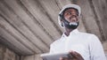 African architects engineer man with tablet work together in the inside the construction building site