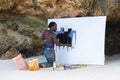 African artist man at work on the beach