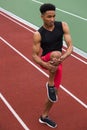 African athlete man make stretching exercises on running track Royalty Free Stock Photo