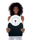African athlete showing weighing scale Royalty Free Stock Photo