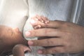 An African baby, 12-day-old baby black skin newborn is holding finger of his mother Royalty Free Stock Photo