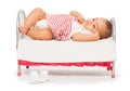 African baby in striped dress on the small bed Royalty Free Stock Photo