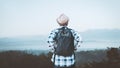 African backpack traveler man looking a sunrise ,fog and landscape on a top of a mountain Royalty Free Stock Photo