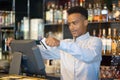 A restaurant worker registrating new order by cash register