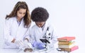 African black boy and caucasian girl studying science in classroom at school Royalty Free Stock Photo