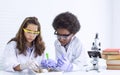 African black boy and caucasian girl studying science in classroom at school Royalty Free Stock Photo