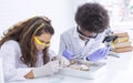 African black boy and caucasian girl studying science in classroom at school Royalty Free Stock Photo
