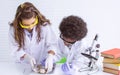 African black boy and caucasian girl studying science in classroom at school Royalty Free Stock Photo