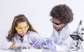 African black boy and caucasian girl studying science in classroom at school Royalty Free Stock Photo