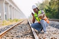 African black engineer women worker work checking service in train railway tracks construction site in transportation industry Royalty Free Stock Photo