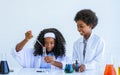 African black girl and boy studying science and making experiment in laboratory with fun, happiness at school. Education and Royalty Free Stock Photo