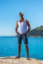 African black man wearing white vest and blue short jeans Royalty Free Stock Photo