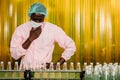 African Black man worker labor working in food and drink industry factory with hygiene work fruit juice production line inspector Royalty Free Stock Photo