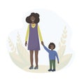 An African Black woman woman with dark skin is walking around holding the hand of her little son. Motherly love. The concept of fa