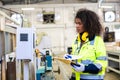 African black women worker work with wood cutter machine furniture factory industry with safety suit Royalty Free Stock Photo