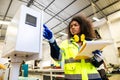 African black women worker work with wood cutter machine furniture factory industry with safety suit Royalty Free Stock Photo