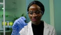 African botanist woman looking at genetic test sample for biological experiment