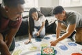 Three friends playing twister in the living room Royalty Free Stock Photo