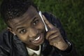 African boy on cell phone outside Royalty Free Stock Photo