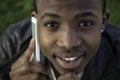 African boy on cell phone outside Royalty Free Stock Photo