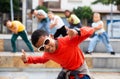 African boy dancing hip-hop with group of tweens on city street