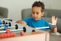 An African boy is having fun playing table football in a children's play entertainment center. Hobby and leisure Royalty Free Stock Photo